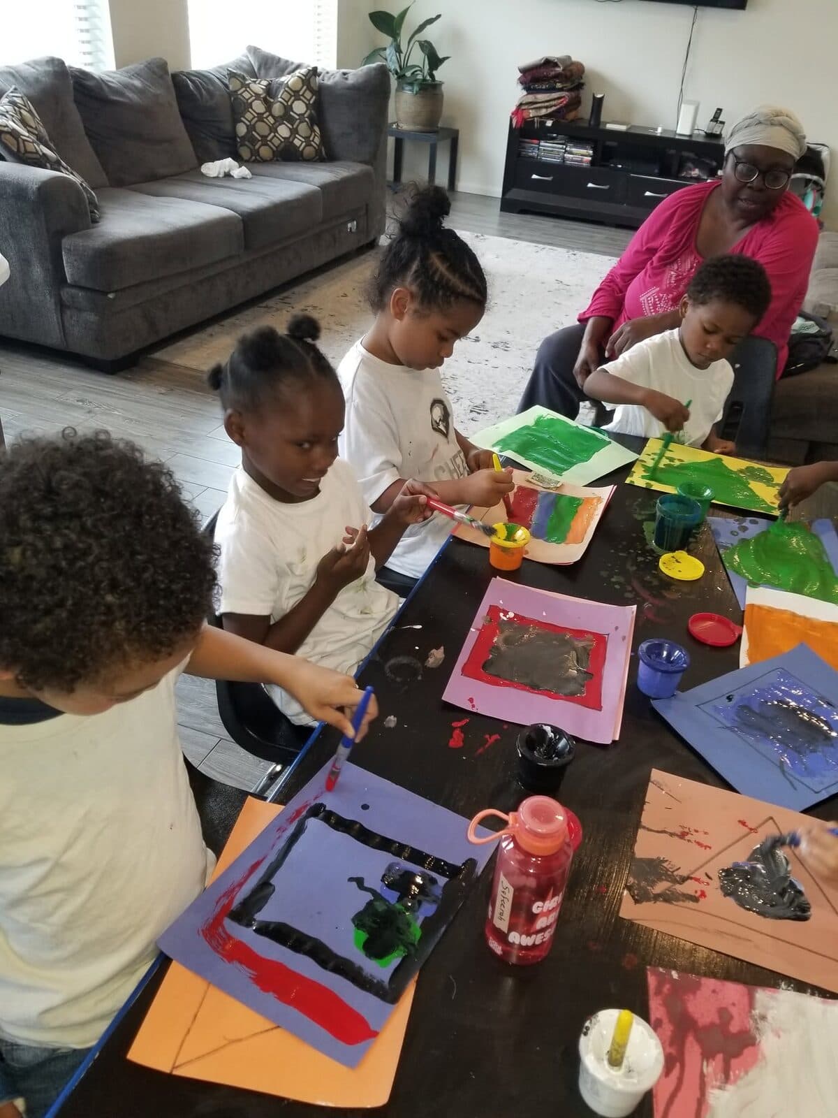 Children making art together in a warm, home-like childcare setting